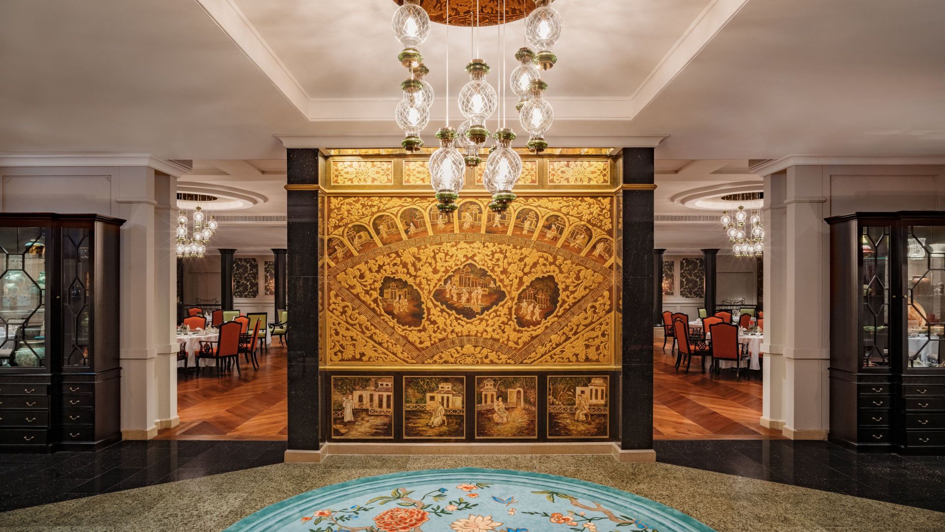 A Room With A Large Gold And Ornate Gold And Black Wall